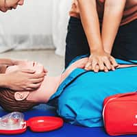 Demonstrating Chest Compressions on a CPR Training Model