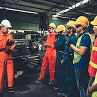 Workers in a warehouse having a safety meeting