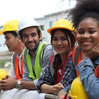 Construction worker team in hard hats smiling