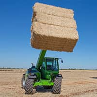 A telescopic handler holding a load of hay