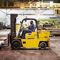 A forklift driver in a warehouse