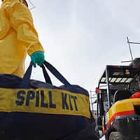 Stack of hard hats with a hand resting on top