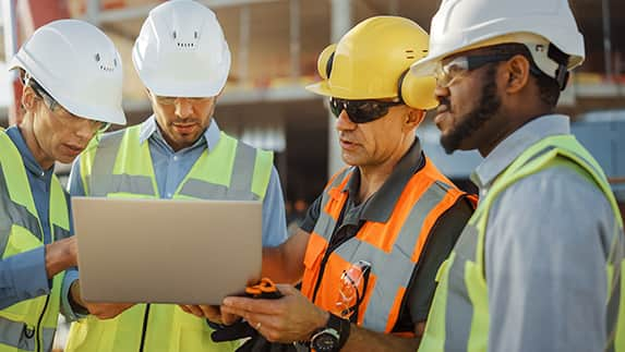 Construction Workers Looking at Plans