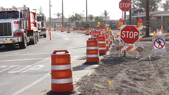 A construction area with a truck positioned next to a stop sign, highlighting the importance of safety protocols on site.